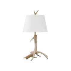 a lamp with antlers on it and a white shade