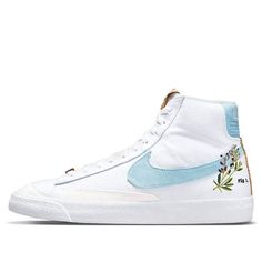 The Nike Blazer Mid '77 is a classic silhouette with a sustainable construction. The shoe's white canvas upper incorporates 20% recycled content by weight, overlaid by tonal synthetic suede and accented by blue on the Swoosh and heel patch, achieved through plant dye. The right heel patch includes a scientific infographic, while the heels of both shoes include an indigo plant graphic. The tongue tag and heel strip are built with recycled cork, with more cork worked into the herringbone rubber ou Nike Blazer Mid 77 White, School Traditions, Plant Graphic, Sustainable Construction, Bday Wishlist, Indigo Plant, Nike Blazers, Nike Blazer Mid 77, Nike Blazer Mid