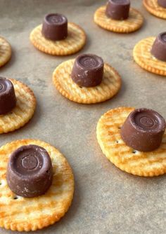 crackers with chocolate on them sitting on a baking sheet