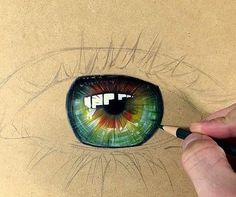 someone is drawing an eye with colored pencils