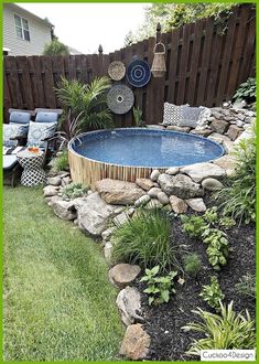 an above ground pool surrounded by rocks and plants