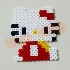 a close up of a hello kitty made out of legos on a white surface