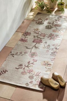 a pair of shoes sitting on the floor next to a rug