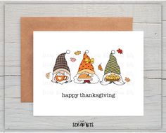 a card with three gnomes wearing thanksgiving hats and the words happy thanksgiving written on it