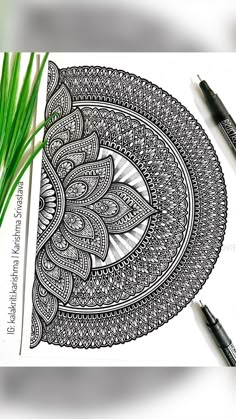 an intricately designed coloring book with green grass in the foreground and two pens next to it