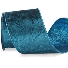 a roll of blue velvet ribbon on a white background