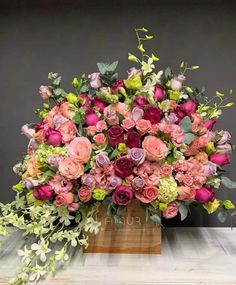 an arrangement of flowers in a vase on a table