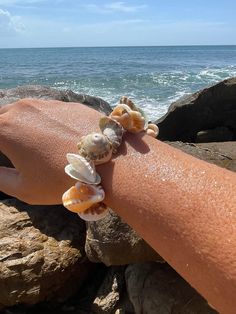 Infused with the waves and sun of the Caribbean & Atlantic Sea, this mixed shell bracelet brings together a variety of shells with different energies for beauty, adornment, and protection. These shells include hermit and trumpet along with snail shells used by tribes including Taino and Arawak. Perfect for the fashionista and person who wants to connect to nature by the sea. .  .  This Spirit Shell piece is made with natural beach materials. Cassandra is a certified Puerto Rican Artisan with the Puerto Rican Department of Economic Development and Commerce. Designs are created with care, deep respect and love for the ocean. They are all one of a kind. Sea Shell Bracelet, Connect To Nature, Porto Rico, Snail Shell, Shell Bracelet, Puerto Rican, The Caribbean, By The Sea, Stretch Bracelet