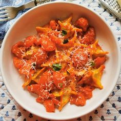 a white bowl filled with pasta and cheese