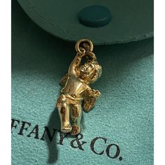 Tiffany & Co. 18k Yellow Gold Cherub Angel Charm Pendant 4 Necklace & Bracelet *Charm Only - Solid Gold 7g Never Worn, Was Cut From The Chain Bracelet, So The Ring Is Open, Any Jeweler Can Solder It Back. In Excellent Condition - Light Hairline Scratches Throughout A Staple Piece For Any Tiffany Lover Or A Great Gift Idea. Metal: 18k Gold Weight: 7 G Pendant: Charm Size Is Approximately 1-1/8” With Bail ( 1” Without The Bail) Hallmarks: T&Co. / 750 Authenticity Guarantee Program Comes With A Pou Gold-tone Jewelry With Logo Charm For Formal Occasions, Luxury Gold Jewelry With Logo Charm, Designer 14k Stamped Yellow Gold Jewelry, Classic Formal Jewelry With Logo Charm, Luxury Jewelry Gift With Logo Charm, Designer Yellow Gold Jewelry Stamped 14k, Luxury Logo Charm Jewelry For Gift, Luxury Charms Jewelry For Formal Occasions, Elegant Jewelry With Logo Charm For Gift