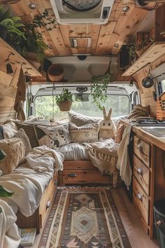 the interior of an rv with wood paneling and plants on the walls, couches, rugs and windows