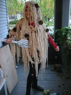 a woman dressed as a macaroni and cheeseburger holding a spatula