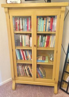 a yellow bookcase filled with lots of books