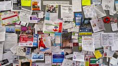 the bulletin board is covered in many different papers