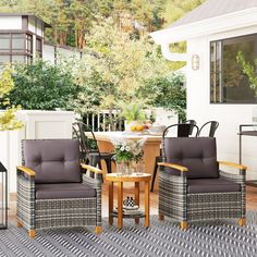 an outdoor patio with chairs, table and potted plant