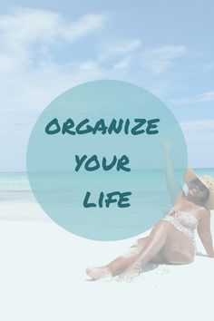 a woman sitting on the beach with her arms up in the air and text that reads, organize your life