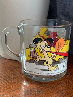 a glass mug with a cartoon character on it