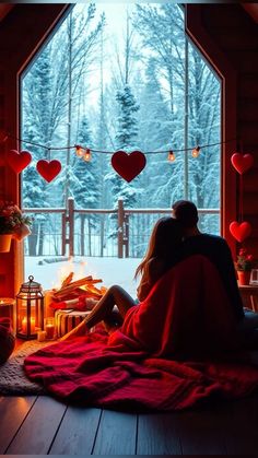 two people sitting in front of a window with hearts hanging from the windowsills