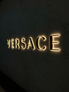 the versa sign is lit up against a wall