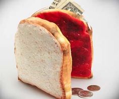 a piece of bread sitting on top of a pile of money