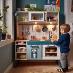 a little boy standing in front of a toy kitchen