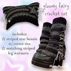 a pair of black and white crocheted boots with laces on them, sitting next to a pillow