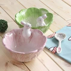 two ceramic bowls with bunny figurines in them