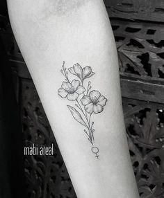 a black and white photo of a flower on the arm