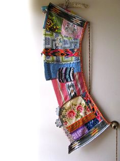 a multicolored piece of cloth hanging on a wall