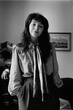 a black and white photo of a woman wearing a tie