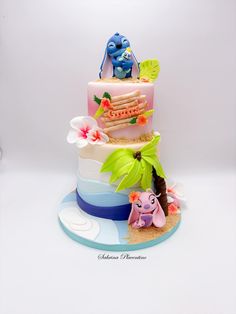 a three tiered cake decorated with cartoon characters