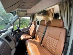 the interior of a vehicle with tan leather seats