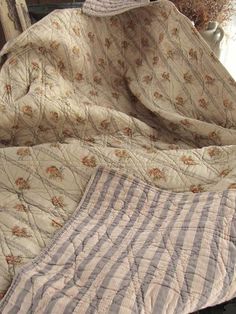 two bedspreads are laying on top of each other