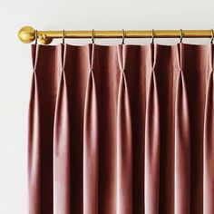 pink curtains hanging on a gold curtain rod