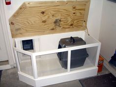 a white shelf with a wooden box on top and some plastic containers in the bottom