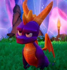 a purple and orange dragon sitting in the grass