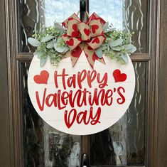 a happy valentine's day door hanger with hearts and greenery on it