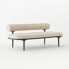 a white couch sitting on top of a wooden frame