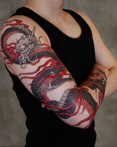 a woman with a dragon tattoo on her arm and arms is posing for the camera