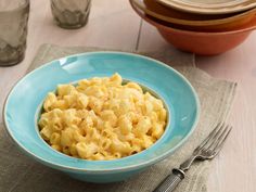 a blue bowl filled with macaroni and cheese