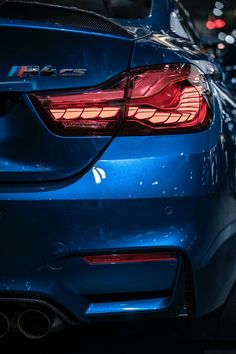 the back end of a blue bmw car