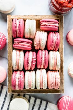 a box filled with pink and white macaroons