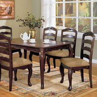 a dining room table with six chairs and a rug on the floor in front of it