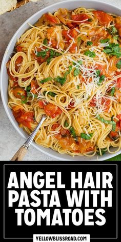 an overhead view of angel hair pasta with tomatoes and parmesan cheese in a white bowl