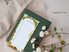 there is a notepad with flowers on it