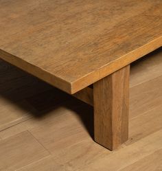 a wooden table sitting on top of a floor next to a hard wood flooring