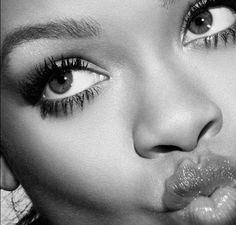 black and white photograph of a woman's face with long lashes on her nose