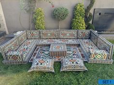 a couch made out of tiles sitting in the grass