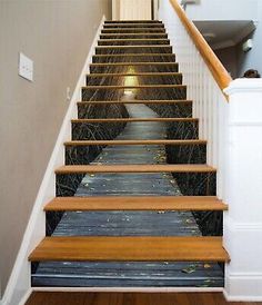 an image of a staircase going up to the second floor with wood handrails