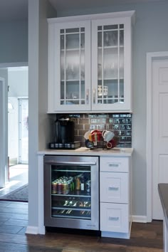 a kitchen with an oven, refrigerator and coffee maker inside of it's cabinet